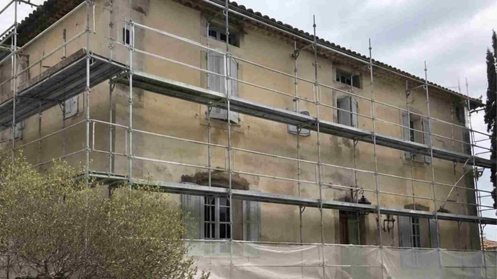Échafaudage périphérique monté sur la bastide aixoise avant purge des enduits, façade en cours de mise à nu