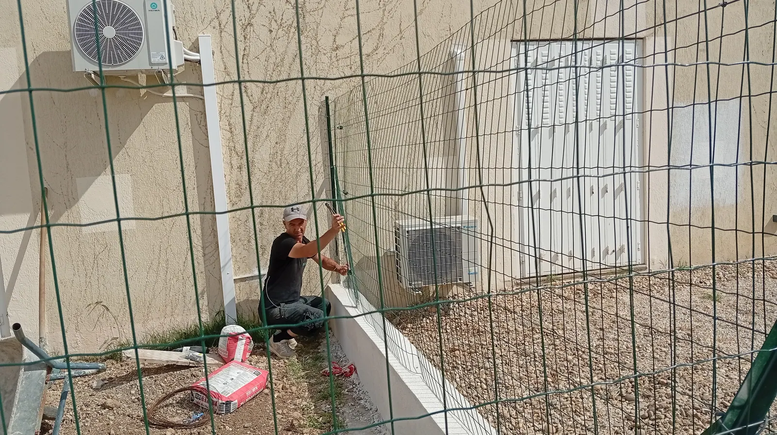 Clôture grillage souple sur muret enduit suivant un terrain en pente à Allauch