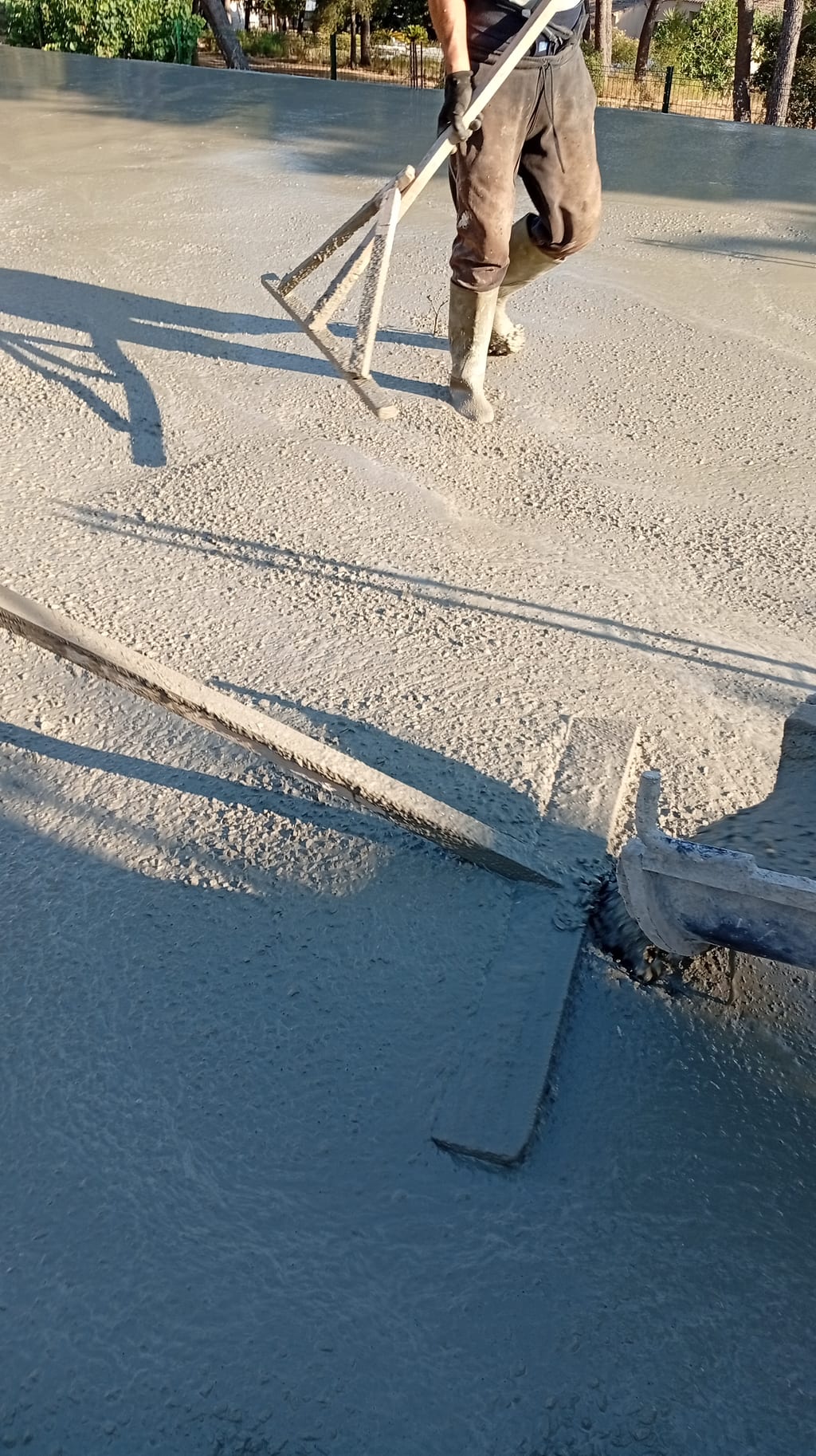 Talochage de finition de la dalle de compression fraîchement coulée — chantier Aix-en-Provence, 9 juillet 2026